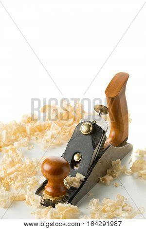 Woodworking hand planer tool on wooden boards in carpenter's workshop against white background with copy space