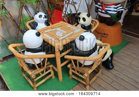 YANGSHOU CHINA - NOVEMBER 18, 2016: Pandas play mahjong display on West Street,