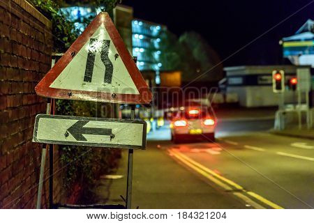 Night View Road Narrows UK Roadworks Sign.