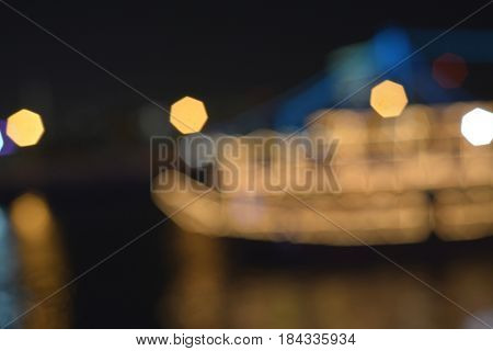 Photography lens blurr effect of dhow cruise. Abstract night city lights background.