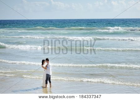 Tender couple on the beach of Sperlonga Italy in a summer day