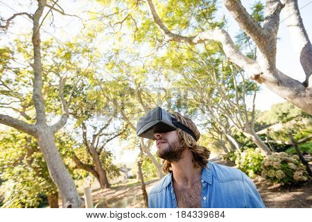 Man using virtual reality glasses in park