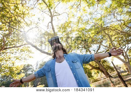 Man using virtual reality glasses in park