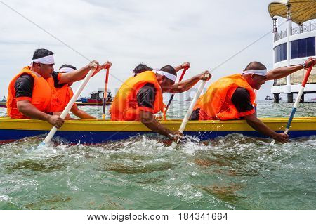Labuan,Malaysia-April 29,2017:Group of boatman with life jacket participate in a boat tug of war games in Labuan International Sea Sports Complex at Labuan,Malaysia on 29th April 2017.