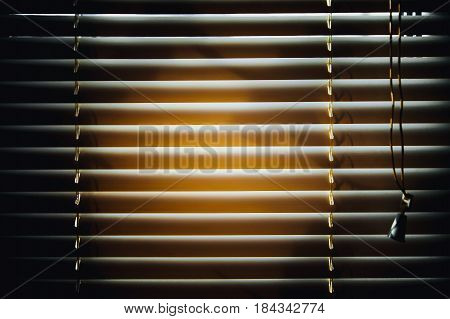 Dark jalousies on sunset background. Horizontal pattern.