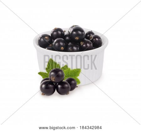 Bowl with blackcurrants isolated on white background. Ripe currants close-up. Background berry. Sweet and juicy berry with copy space for text. Antioxidant and the best berry a source of vitamin C
