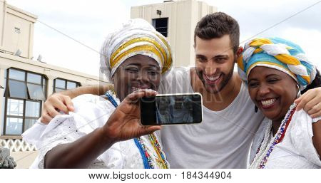Tourist taking a selfie with tradicional Brazilian Women - Baianas