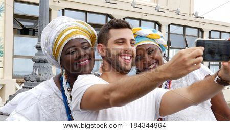 Tourist taking a selfie with tradicional Brazilian Women - Baianas