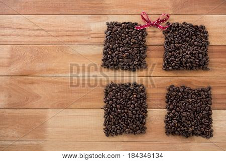 Roasted coffee beans forming shape on wooden background