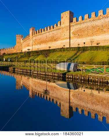 Walled city of Cittadella, brick wall mirror reflected in the water, province of Padua, Italy