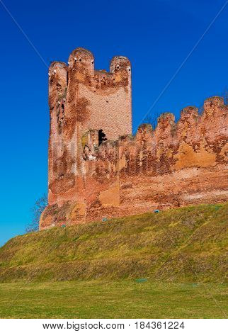 Medieval watchtower and wall made of red bricks against the clear blue sky, walled town of Castelfranco, Veneto, Northern Italy