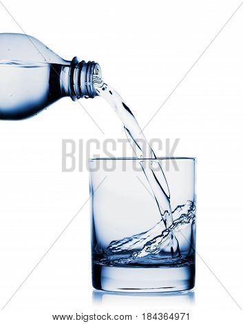 Water pouring into wide glass from bottle isolated on white background