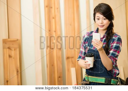 Carpenter Texting And Hoding Cup Coffee