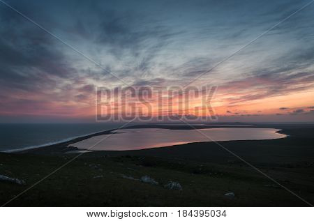 Sunset over the sea and lakes. Opuk. Crimea. Russia