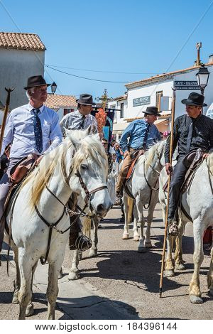 Sent-Mari-de-la-Mer, Provence, France - May 25, 2015. World Festival of Gypsies. Convoy on white horse before start of the parade. The concept of ethnographic tourism