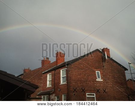 Magnificent Rainbow on Grey Skies and beautiful buildings