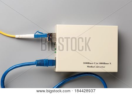 1Gbps optical media converter with SFP module connected to fiber patch cord and copper patchcord with RJ45 connector