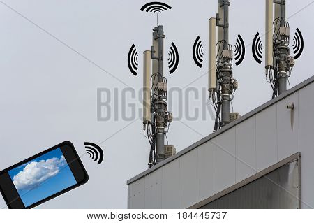 Antenna telecommunications tower on a roof. Wireless telecommunication concept home control by smartphone.