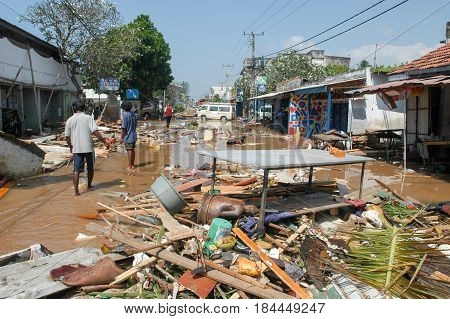 Hikkaduwa Sri Lanka - 26 December 2004: people walking on the debris after the tsunami at Hikkaduwa in Sri Lanka