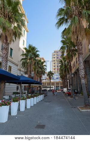 Salerno Italy - September 1 2016: View of Via Ulisse Abbagnano street with cafes and palm trees