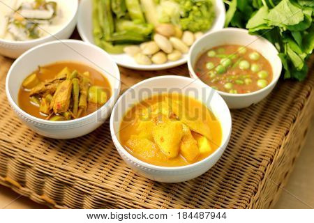 Sour soup with fish and bamboo shoot fish organs sour soup chili paste spicy thai food menu on rattan table