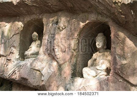 Yuantouzhu - Taihu scenery garden, Wuxi, China APRIL 2017 : the stone Buddha on the stone wall