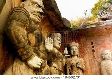 Yuantouzhu - Taihu scenery garden, Wuxi, China APRIL 2017 : Big stone Buddha on the stone wall