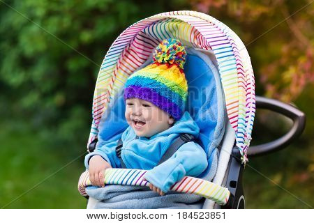 Baby Boy In Stroller In Autumn Park