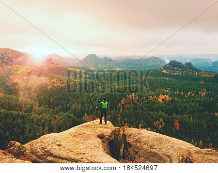 Photographer Working With Mirror Camera And Tripod On Peak Of Rock. Dreamy Fogy Landscape
