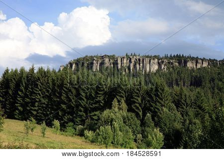 Peak in Table Mountain, view from Pasterka village. Szczeliniec Wielki i Szczeliniec Maly highest peaks in Stolowe Mountain in Poland by summer sunset.
