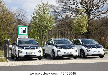 Frankfurt Germany - March 30 2017: Three BMW i3 electric vehicles at a charging station