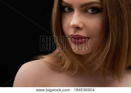Cropped close up of an attractive young woman with blue eyes and full sexy sensual lips on dark background copyspace beauty sensuality femininity cosmetology hairstyle skincare makeup glamour concept.