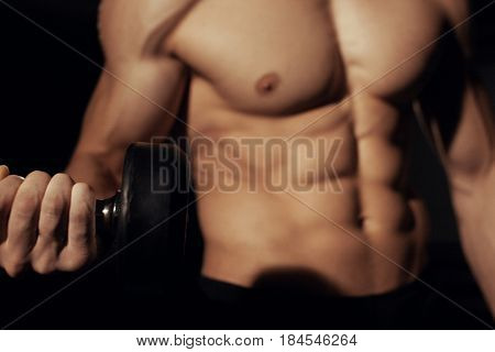 bodybuilder doing heavy weight exercise for biceps with dumbbell