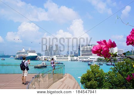 Singapore, Singapore - February 13, 2017: People walk alongside the Sentosa Island near bay in Singapore.