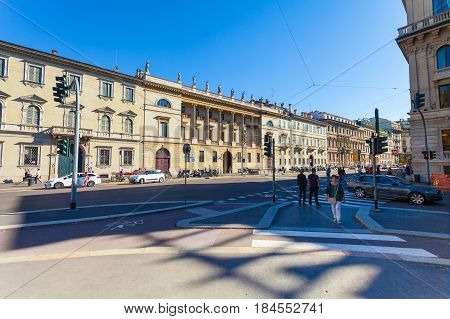MILAN ITALY - September 06 2016: Pedestrians are waiting the green light of traffic light on the crossroad on Avenue Buenos Aires (Corso Buenos Aires) and street Palestro where there is a bicycle lane for bicyclists