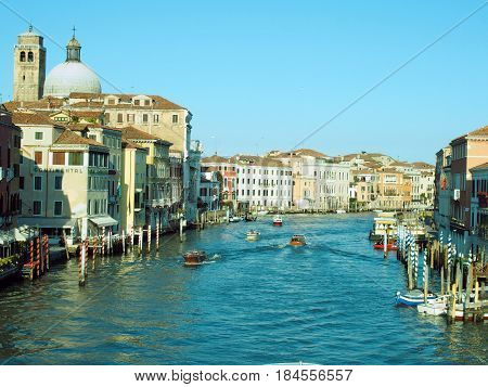 The grand canal in venice on a bright sunny day with a small boat sailing