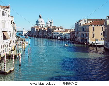 Grand canal in Venice on a bright sunny day with boat and clear blue sky