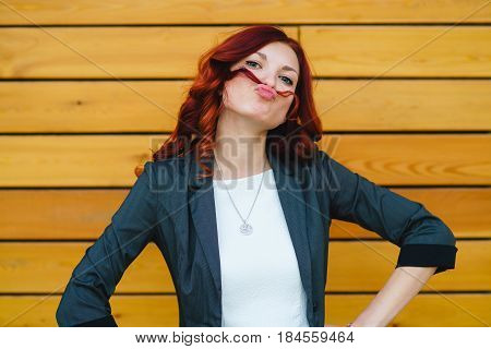 A Girl Makes A Mustache Out Of Her Hair