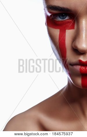 Half Face of Woman with tribalistic red Paint Make-up