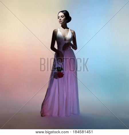 Art fashion studio photo of beautiful elegant woman on colors background. Drawing of shadows and colors. Light and color effects. Fashion style 
