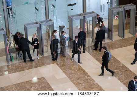 Moscow, Russia - April 24, 2017: Visitors passing security check at Synergy Global Forum at Crocus Expo Hall. This is one of the largest business forums with more than 5000 participants