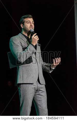 Moscow, Russia - April 24, 2017: Famous Russian showman Ivan Urgant performs at Synergy Global Forum at Crocus Expo Hall. This is one of the largest business forums with more than 5000 participants