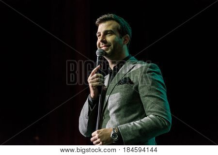 Moscow, Russia - April 24, 2017: Famous Russian showman Ivan Urgant performs at Synergy Global Forum at Crocus Expo Hall. This is one of the largest business forums with more than 5000 participants