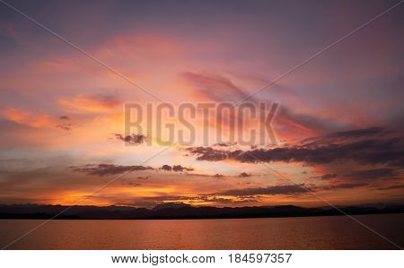 Dramatic sunset sky with orange colored clouds.