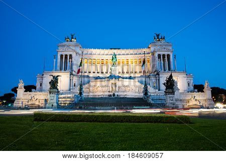 Venezia Palace /Palazzo Venezia/ - the palace of Victor Emmanuel at the Venezia Square /Piazza Venezia/ in Rome Italy at night. Long exposure car lights trails effect.