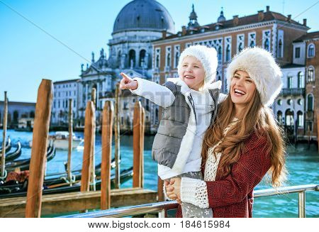 Mother And Daughter Tourists In Venice Looking Into Distance