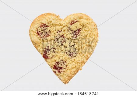 Streusel or crumble heart with jam on wood