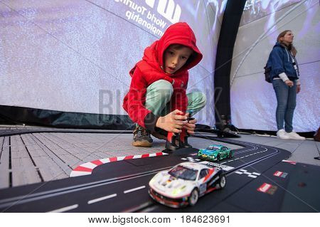 Moscow, Russia - 12 June 2016: world championship WTCC at the Moscow Raceway. A boy playing RC car model
