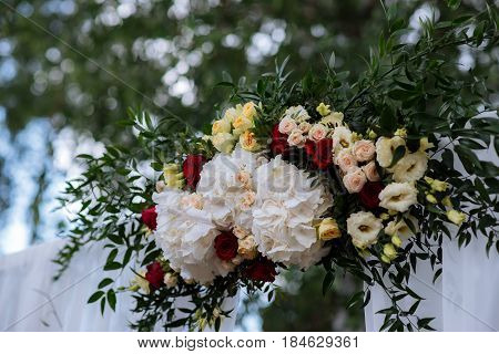 Beautiful Wedding Ceremony Outdoors. Decorated Chairs Stand On The Grass. Wedding Arch Made  Flowers