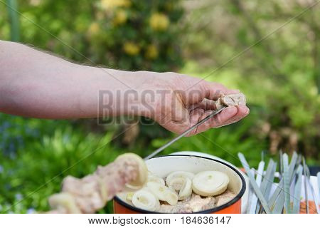 Man stringing meat on a skewer. Shashlik - cooking barbecue. Stringing meat on ramrod.